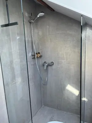 a shower with a glass door in a bathroom at Au petit Marius in Cannes
