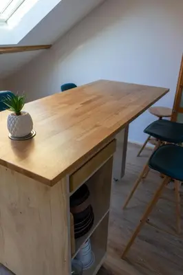 a wooden table in a room with chairs at Au petit Marius in Cannes