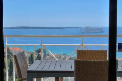 a table and chairs with a view of the ocean at IMMOGROOM - sea view - Pool - Terrace - Parking - Wifi - AC in Cannes