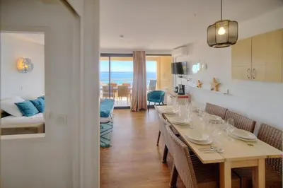 a dining room with a table with wine glasses on it at IMMOGROOM - sea view - Pool - Terrace - Parking - Wifi - AC in Cannes