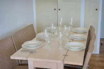 a table with plates and wine glasses on it at IMMOGROOM - sea view - Pool - Terrace - Parking - Wifi - AC in Cannes
