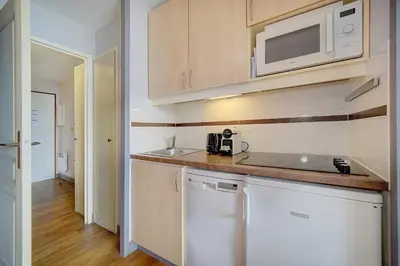 a kitchen with a counter top and a microwave at IMMOGROOM - 2 Rooms sea view - Swimming pool - Terrace - Parking - AC in Cannes