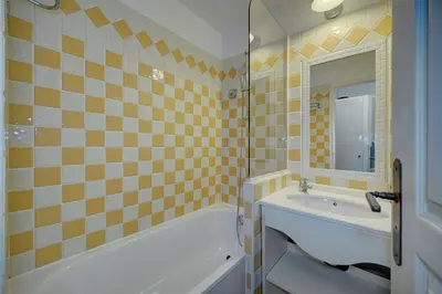 a bathroom with a tub and a sink and a bath tub at IMMOGROOM - 2 Rooms sea view - Swimming pool - Terrace - Parking - AC in Cannes