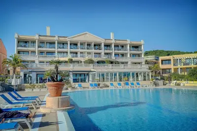 a large hotel with a swimming pool in front of it at IMMOGROOM - 2 Rooms sea view - Swimming pool - Terrace - Parking - AC in Cannes