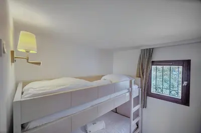 a bedroom with a bunk bed and a window at IMMOGROOM - 2 Rooms - Renovated - Pool - Parking - Air conditioning - in Cannes