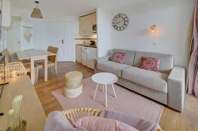 a living room with a couch and a table at IMMOGROOM - 2 Rooms renovated - Pool - Terrace - Garden - Parking - in Cannes