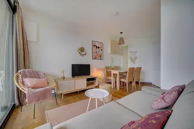 a living room with a couch and a table at IMMOGROOM - 2 Rooms renovated - Pool - Terrace - Garden - Parking - in Cannes