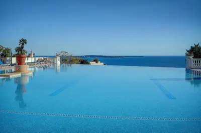 a large swimming pool with a view of the ocean at IMMOGROOM - 2 Rooms - Renovated - Pool - Air conditioning - Parking - Wifi in Cannes