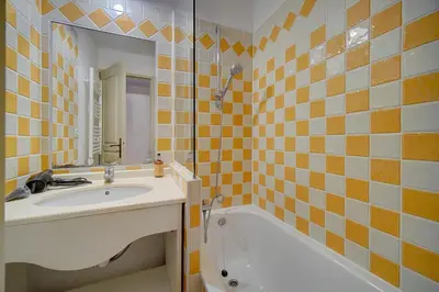 a bathroom with a sink and a bath tub at IMMOGROOM - 2 Rooms - Renovated - Pool - Air conditioning - Parking - Wifi in Cannes