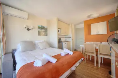 a bedroom with a large bed with two pillows on it at IMMOGROOM - 2 Rooms sea view - Swimming pool - Terrace - Parking - AC in Cannes