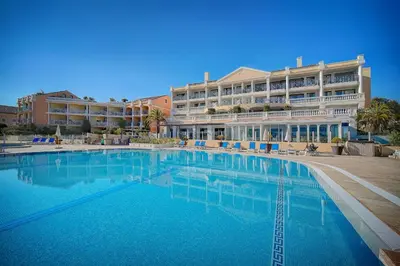 a large swimming pool in front of a hotel at IMMOGROOM - 2 Rooms sea view - Swimming pool - Terrace - Parking - AC in Cannes