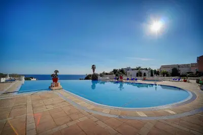 a large swimming pool with the ocean in the background at IMMOGROOM - 2 Rooms sea view - Swimming pool - Terrace - Parking - AC in Cannes