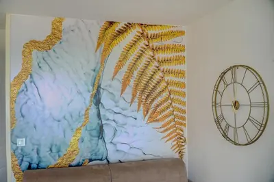 a painting on a wall next to a clock at IMMOGROOM - 2 Rooms sea view - Renovated - Pool - Terrace - Parking - AC in Cannes