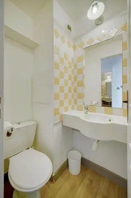 a bathroom with a toilet and a sink and a mirror at IMMOGROOM - 2 Rooms sea view - Renovated - Pool - Terrace - Parking - AC in Cannes