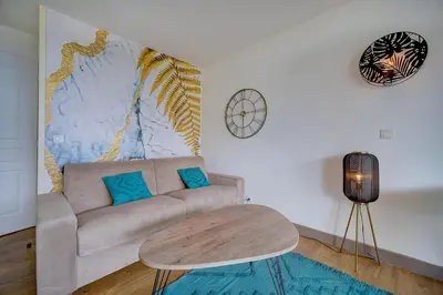 a living room with a couch and a table at IMMOGROOM - 2 Rooms sea view - Renovated - Pool - Terrace - Parking - AC in Cannes