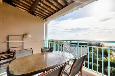 a balcony with a table and chairs and a view of the ocean at Résidence Cannes Villa Francia - maeva Home - Appartement 3 Pièces 6 Personnes - Confort MAE-7944 in Cannes