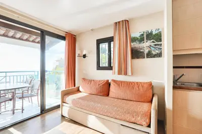 a living room with a couch and a balcony at Résidence Cannes Villa Francia - maeva Home - Appartement 3 Pièces 6 Personnes - Confort MAE-7944 in Cannes