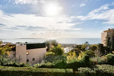 a view of the ocean from a garden at Résidence Cannes Villa Francia - maeva Home - Appartement 3 Pièces 6 Personnes - Confort MAE-7944 in Cannes