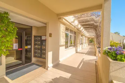 a corridor of a building with flowers and an arcade at Cannes Stunning sea and old town view for our full comfort 3 BR with balcony by Olam Properties in Cannes