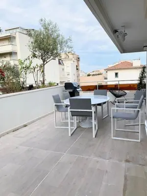 a patio with a table and chairs on a balcony at ROOFTOP CROISETTE/ALEXANDRE III in Cannes