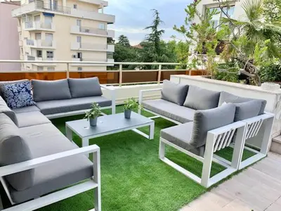 a patio with couches and tables on a balcony at ROOFTOP CROISETTE/ALEXANDRE III in Cannes
