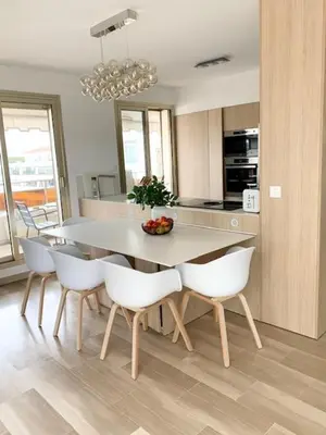 a kitchen with a table and white chairs in a room at ROOFTOP CROISETTE/ALEXANDRE III in Cannes