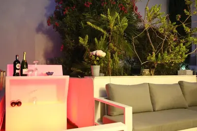 a couch and a table with bottles of wine at ROOFTOP CROISETTE/ALEXANDRE III in Cannes