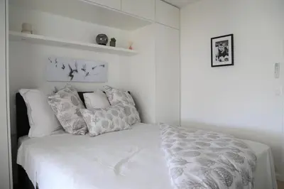 a bedroom with a bed with white sheets and pillows at ROOFTOP CROISETTE/ALEXANDRE III in Cannes