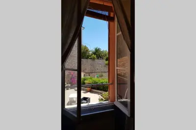 an open window with a view of a garden at C069-Magnifique appartement au coeur du suquet in Cannes
