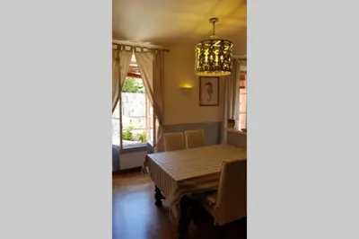 a dining room with a table and a chandelier at C069-Magnifique appartement au coeur du suquet in Cannes