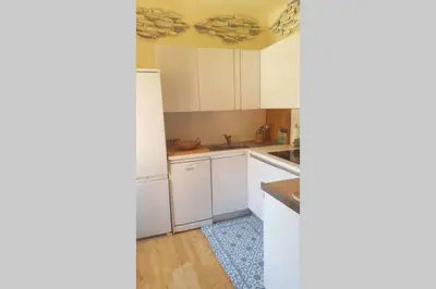 a kitchen with white cabinets and a blue rug at C069-Magnifique appartement au coeur du suquet in Cannes