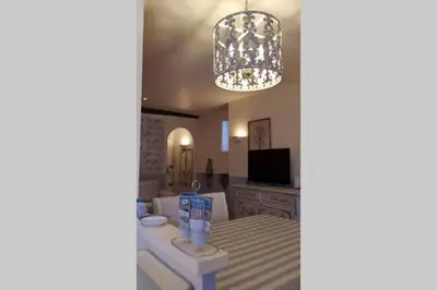 a living room with a chandelier and a bathroom at C069-Magnifique appartement au coeur du suquet in Cannes