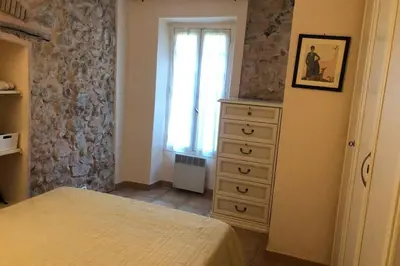 a bedroom with a bed and a dresser and a window at C054-Bel Appartement Lumineux au Coeur du Suquet in Cannes
