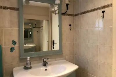 a bathroom with a sink and a mirror at C054-Bel Appartement Lumineux au Coeur du Suquet in Cannes