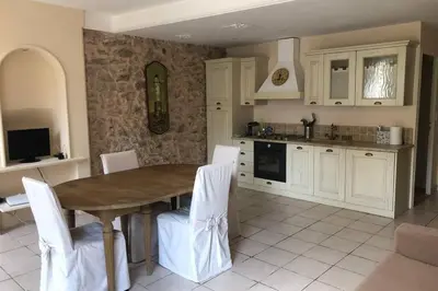 a kitchen with a wooden table and white cabinets at C054-Bel Appartement Lumineux au Coeur du Suquet in Cannes