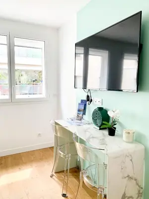 a kitchen with a white counter and two windows at Superbes studios entièrement rénovés - 50m croisette in Cannes