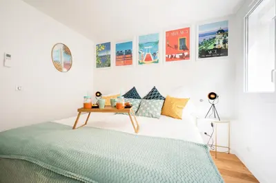 a bedroom with a bed and a table at Superbes studios entièrement rénovés - 50m croisette in Cannes