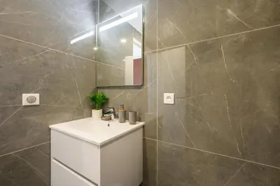 a bathroom with a white sink and a mirror at Superbes studios entièrement rénovés - 50m croisette in Cannes