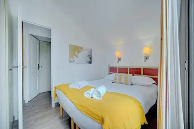a bedroom with two beds with towels on them at IMMOGROOM - 3 Rooms - Renovated - Pool - Air conditioning - Parking - Wifi in Cannes