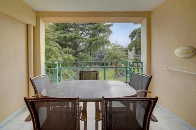 a table and chairs on a balcony with a view at IMMOGROOM - 3 Rooms - Renovated - Pool - Air conditioning - Parking - Wifi in Cannes