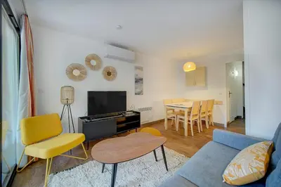 a living room with a couch and chairs and a table at IMMOGROOM - 3 Rooms - Renovated - Pool - Air conditioning - Parking - Wifi in Cannes
