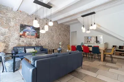 a living room with blue couches and a dining room at Villa Terra by Festif Azur - House 250m2 Quiet, 5 min walk from Palais des Festivals and Beaches in Cannes