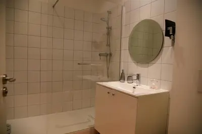 a bathroom with a sink and a shower with a mirror at Villa Terra by Festif Azur - House 250m2 Quiet, 5 min walk from Palais des Festivals and Beaches in Cannes