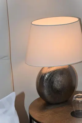 a lamp sitting on top of a wooden table at Villa Terra by Festif Azur - House 250m2 Quiet, 5 min walk from Palais des Festivals and Beaches in Cannes
