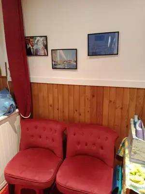 two red seats in a room with pictures on the wall at Cadre de rêve mais vous faites le ménage- very good prices but you have to clea-n th-e flat in Cannes