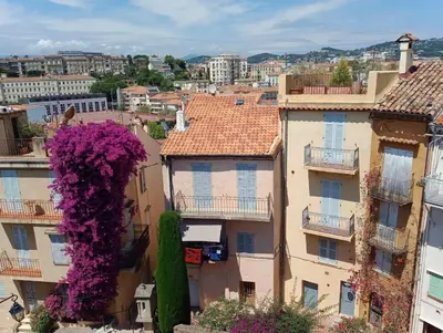 a view of a city with buildings with purple flowers at Cadre de rêve mais vous faites le ménage- very good prices but you have to clea-n th-e flat in Cannes