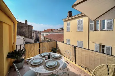 a balcony with a table with plates on it at IMMOGROOM - Splendid Terrace - Studio - Central in Cannes