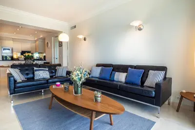 a living room with a couch and a table at Cannes Croisette Superbe 3P front de mer in Cannes