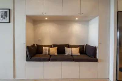 a living room with a couch in a wall at Cannes Croisette Superbe 3P front de mer in Cannes