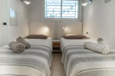 two twin beds in a room with a window at Cannes Croisette Superbe 3P front de mer in Cannes